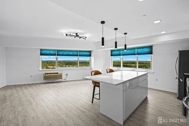 a view of a kitchen with a sink and a large window