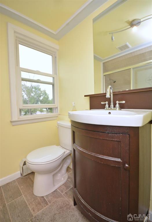 355 Metlars Lane Piscataway, NJ 08854 - Photo 15 of 29 a bathroom with a sink toilet and window