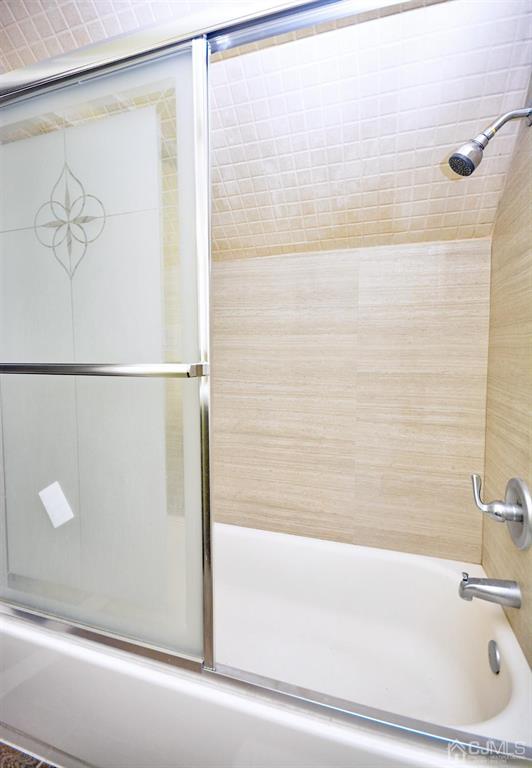 355 Metlars Lane Piscataway, NJ 08854 - Photo 16 of 29 a bathroom with a bathtub and a shower