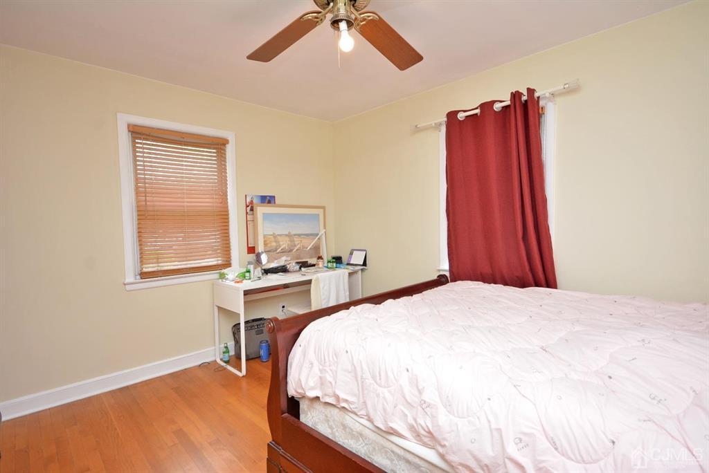355 Metlars Lane Piscataway, NJ 08854 - Photo 17 of 29 a bed room with a bed and a chair