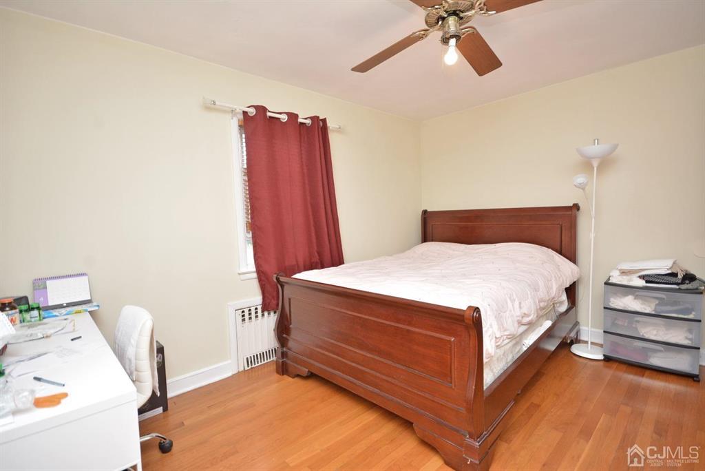 355 Metlars Lane Piscataway, NJ 08854 - Photo 18 of 29 a bedroom with a bed and a dresser