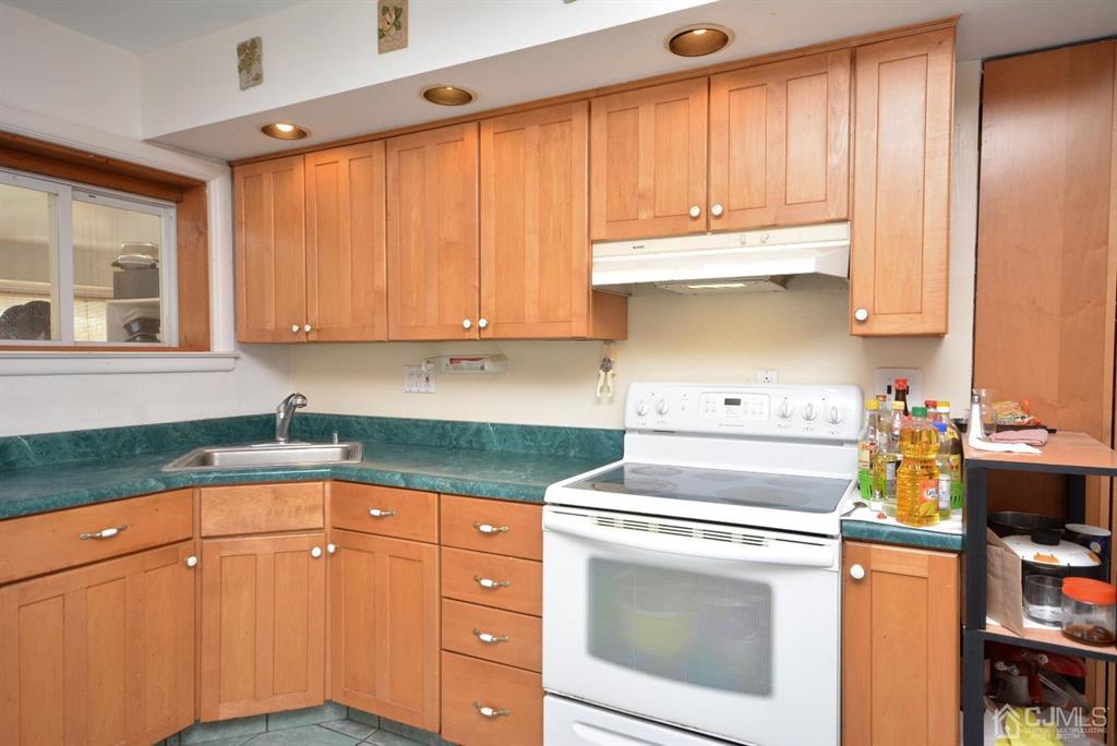 355 Metlars Lane Piscataway, NJ 08854 - Photo 23 of 29 a kitchen with granite countertop a stove a sink and dishwasher