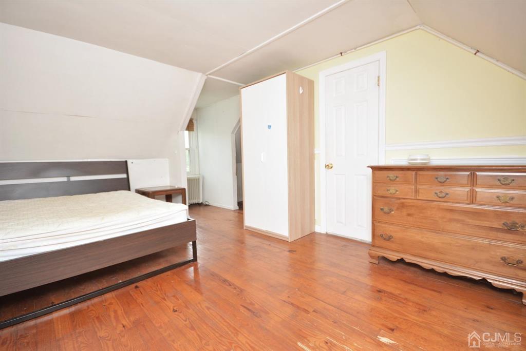 355 Metlars Lane Piscataway, NJ 08854 - Photo 8 of 29 a spacious bedroom with a bed and cabinet