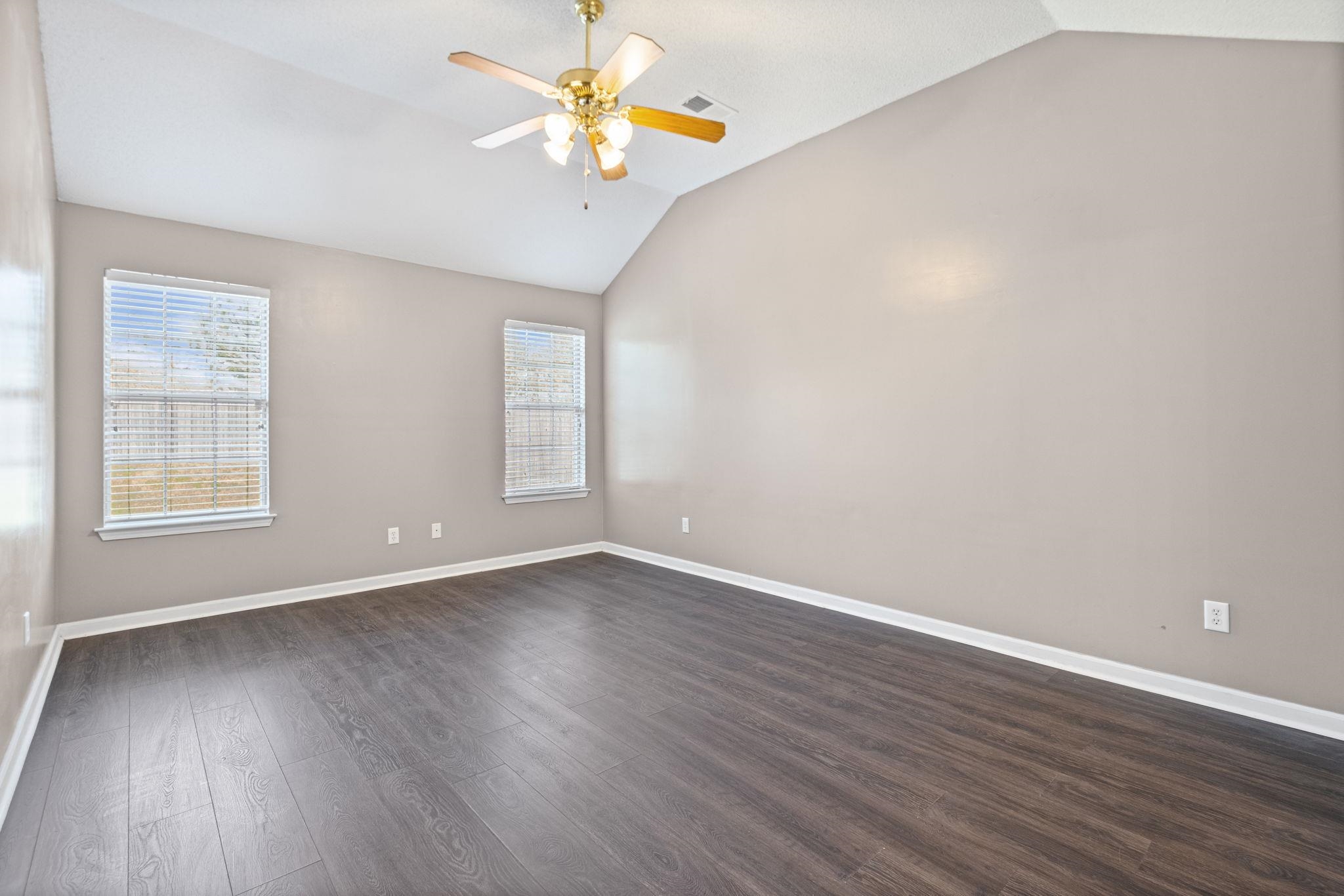 10018 Cameron Ridge Trail Memphis, TN 38016 - Photo 14 of 29 a view of an empty room with window and wooden floor