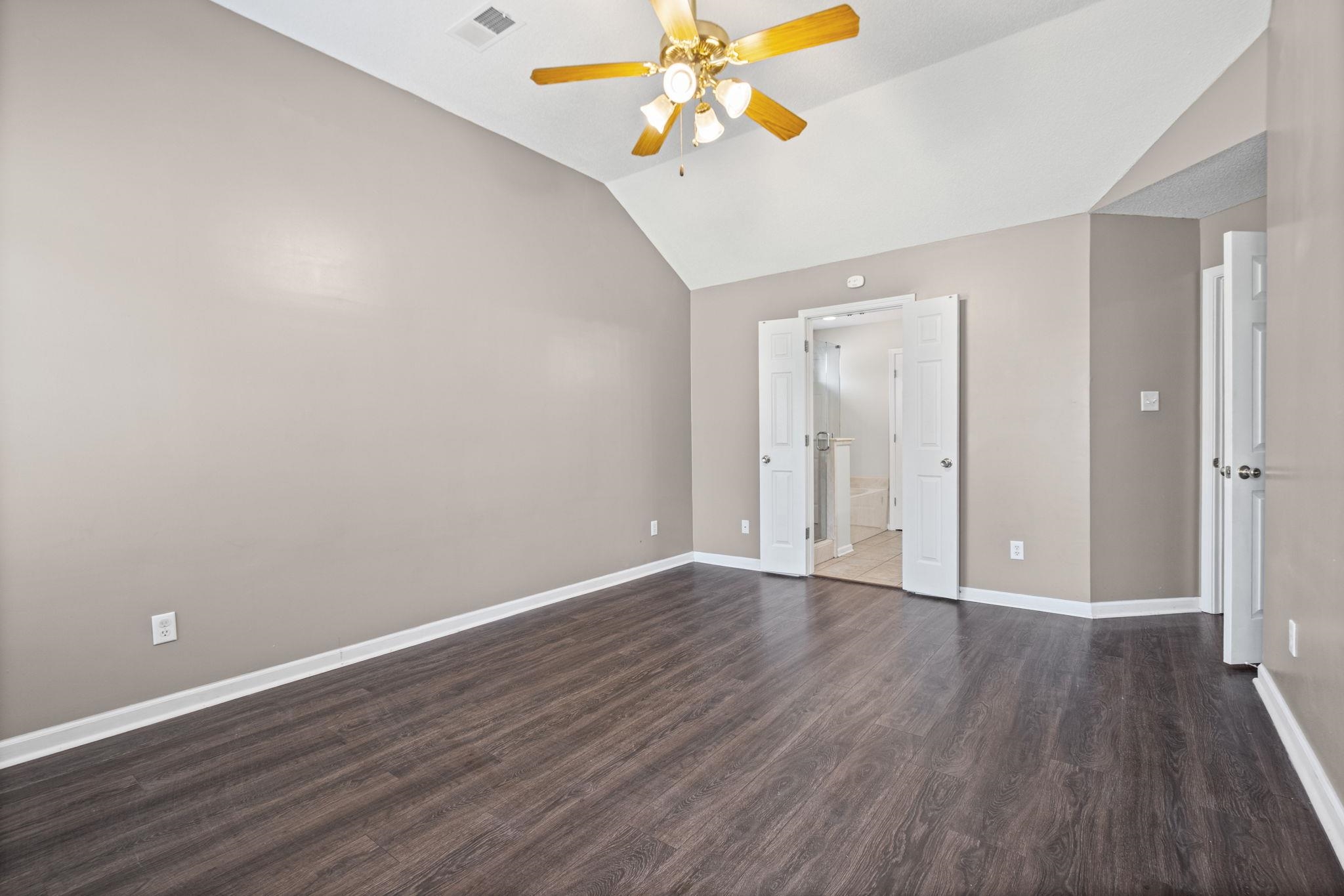 10018 Cameron Ridge Trail Memphis, TN 38016 - Photo 15 of 29 wooden floor in an empty room with a window
