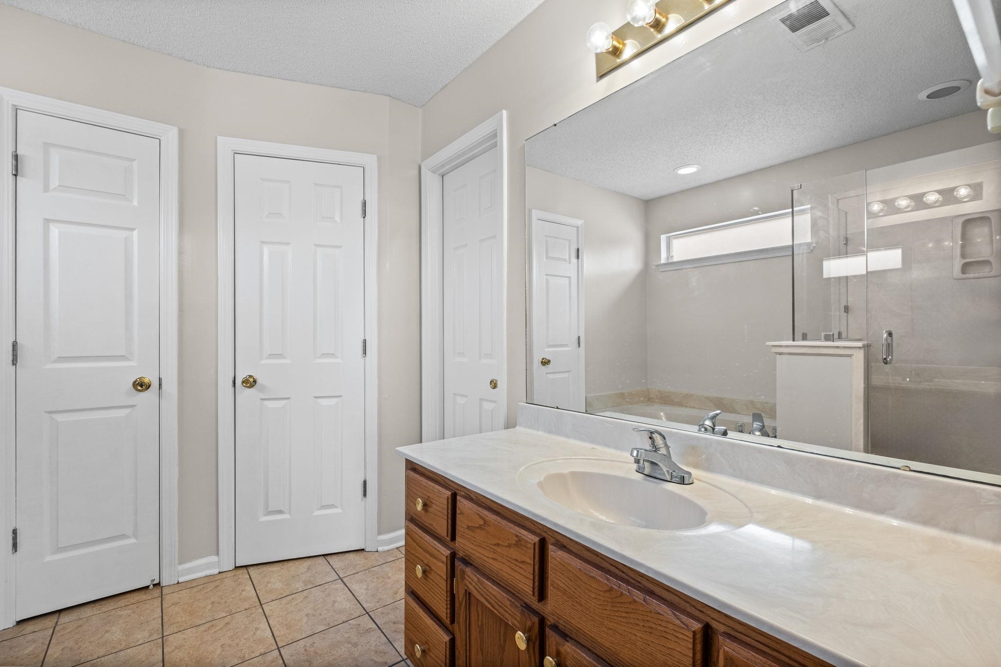 10018 Cameron Ridge Trail Memphis, TN 38016 - Photo 17 of 29 a bathroom with a sink and a mirror