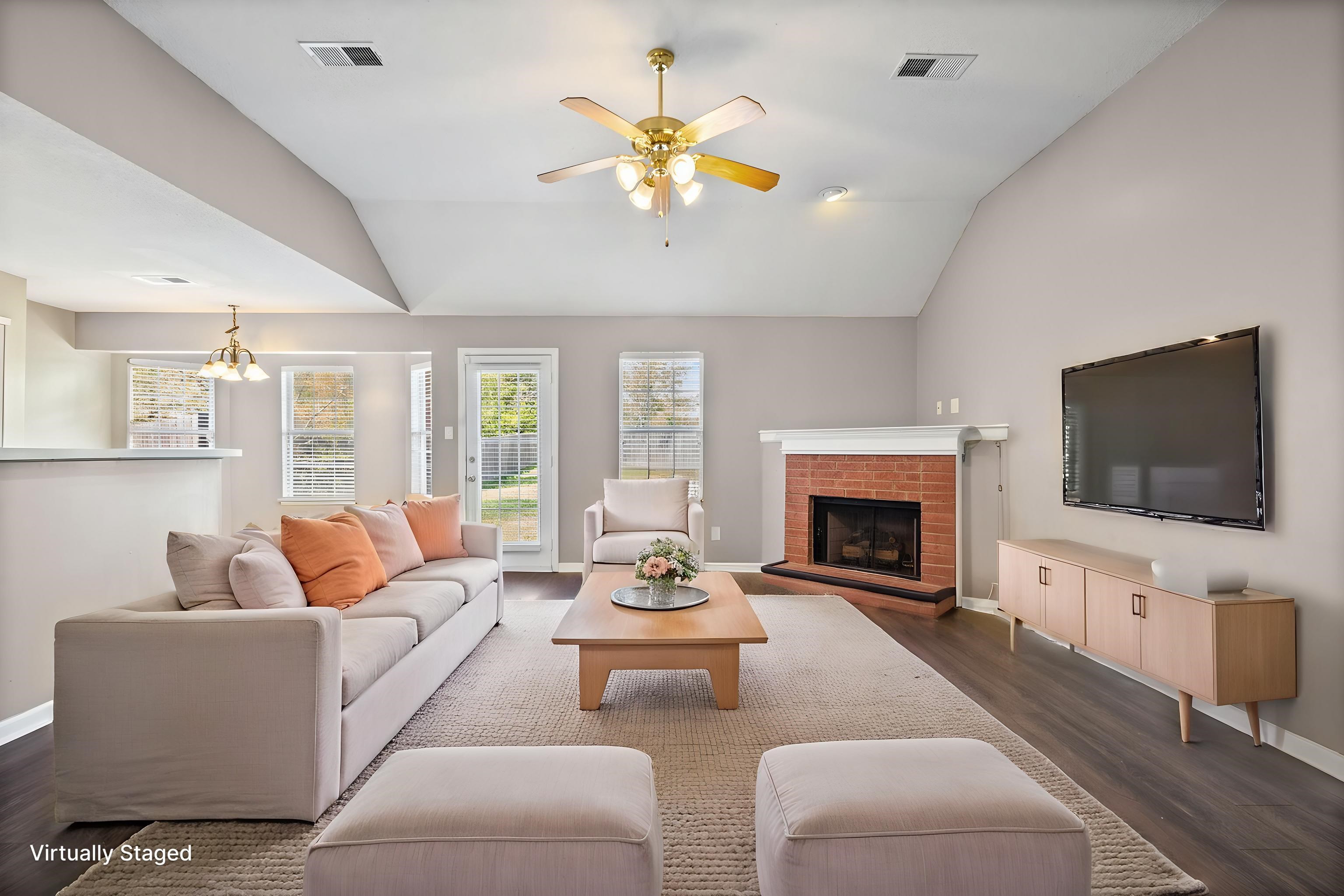 10018 Cameron Ridge Trail Memphis, TN 38016 - Photo 2 of 29 a living room with furniture a fireplace and a flat screen tv