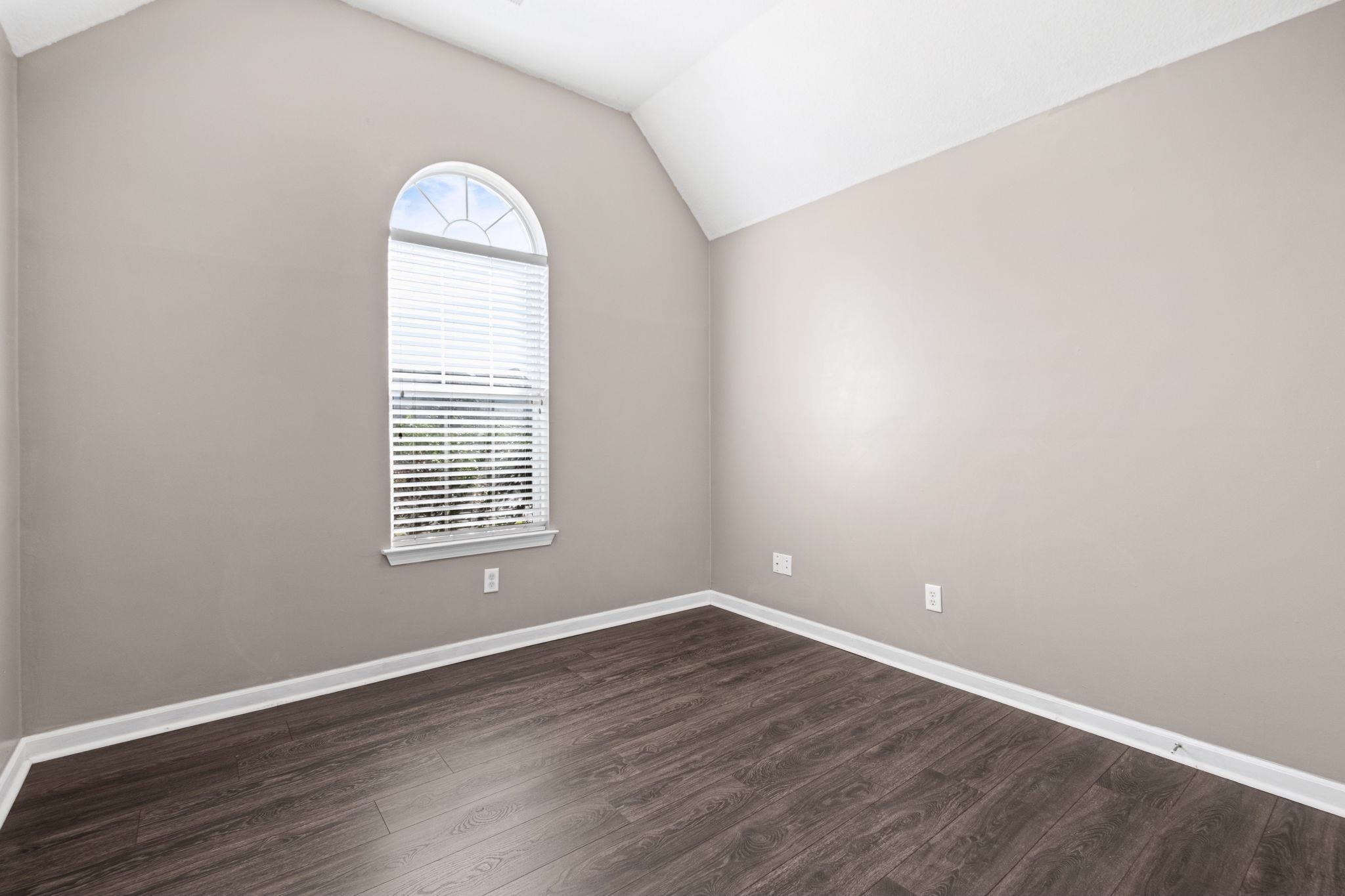 10018 Cameron Ridge Trail Memphis, TN 38016 - Photo 21 of 29 an empty room with wooden floor and a window