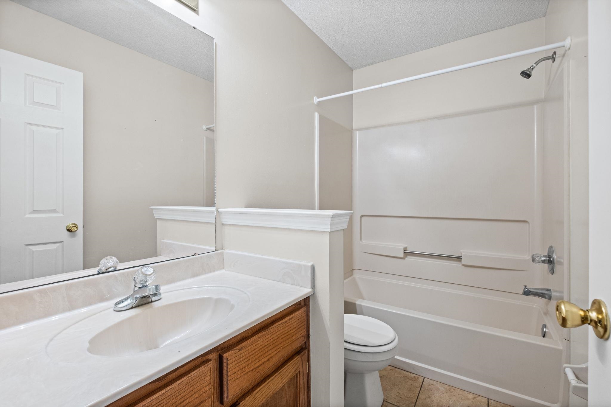 10018 Cameron Ridge Trail Memphis, TN 38016 - Photo 24 of 29 a bathroom with a sink a toilet and shower