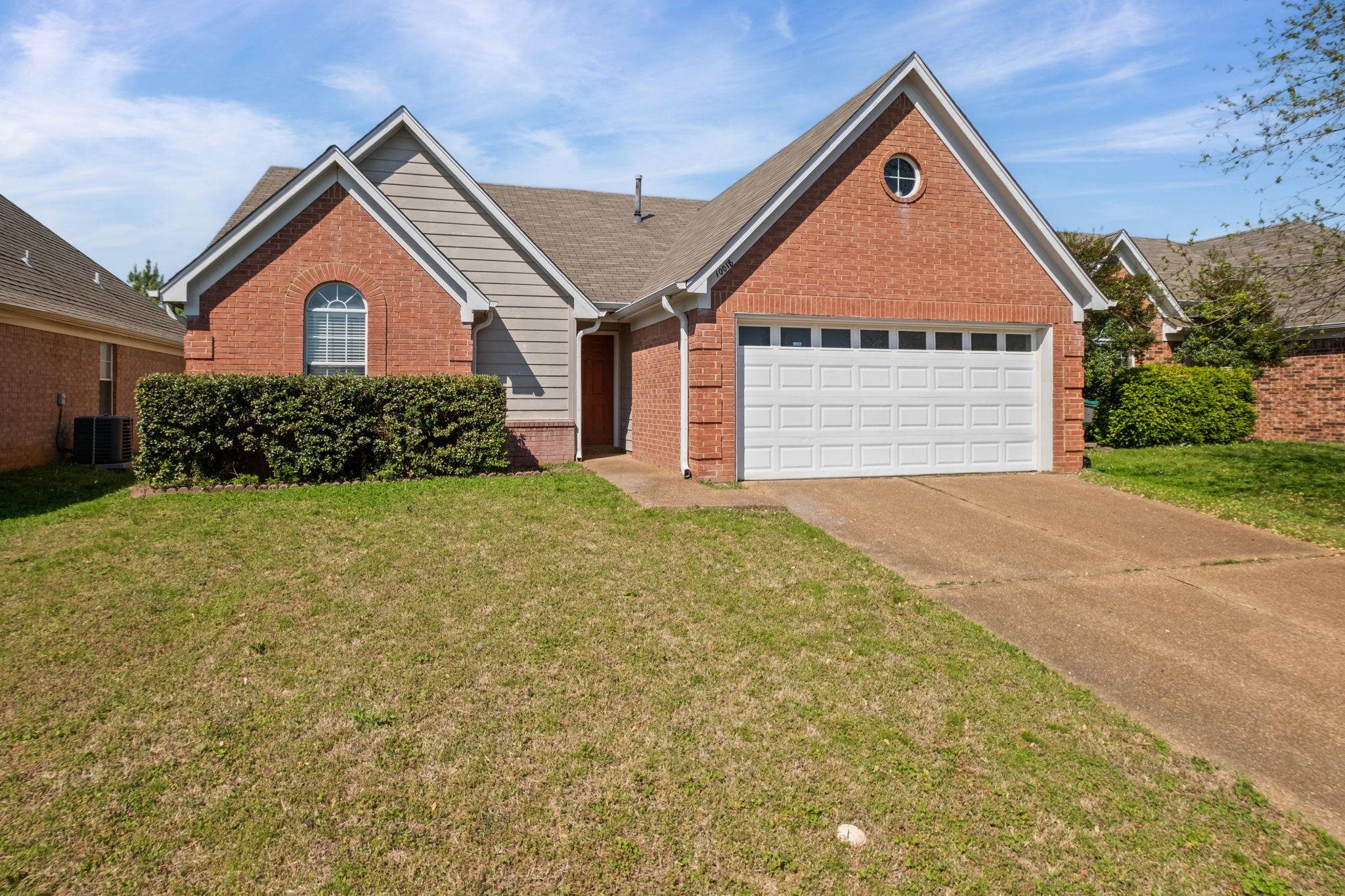 10018 Cameron Ridge Trail Memphis, TN 38016 - Photo 28 of 29 a front view of a house with a yard and garage