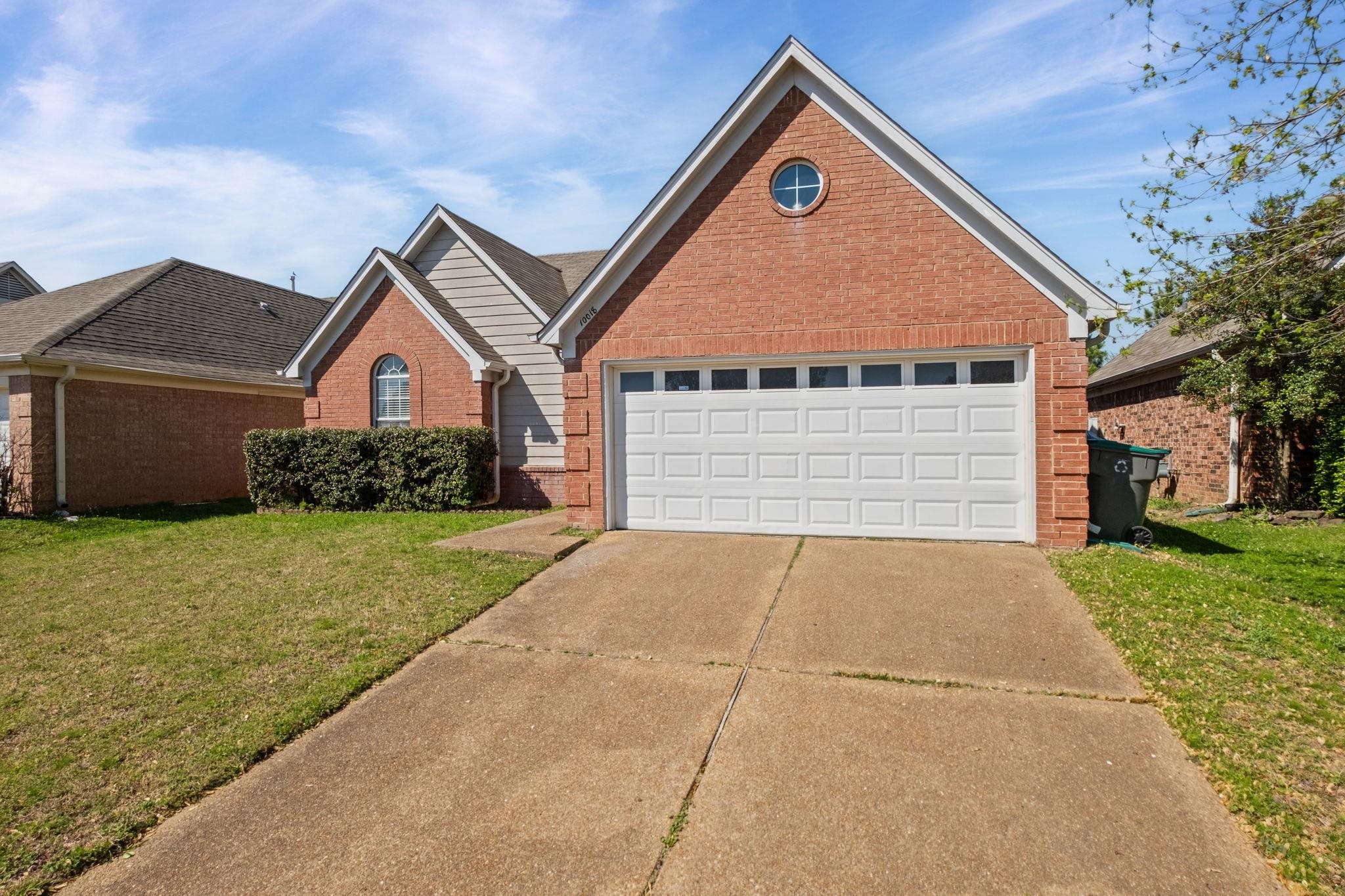 10018 Cameron Ridge Trail Memphis, TN 38016 - Photo 29 of 29 a front view of a house with a garden