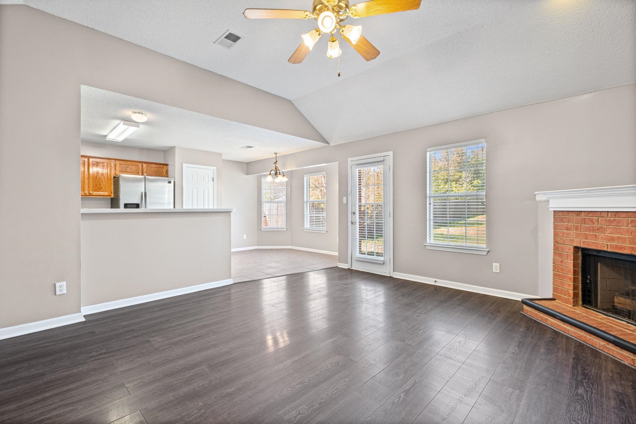 10018 Cameron Ridge Trail Memphis, TN 38016 - Photo 5 of 29 a view of an empty room with wooden floor and a window