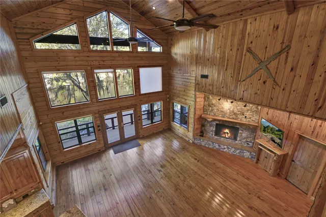 a view of a livingroom with fireplace and wooden floor