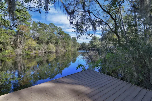 a aerial view of a house with a yard basket ball court and outdoor seating