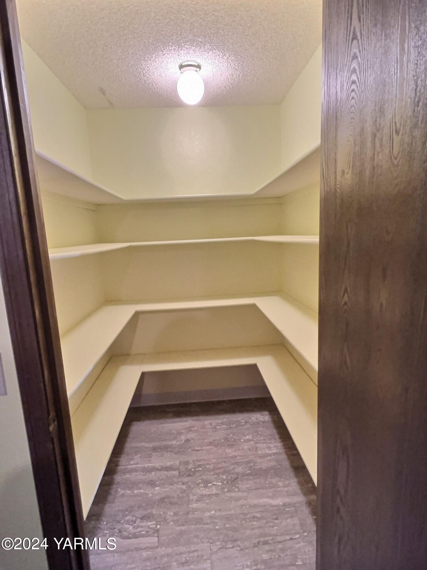 408 Wyant Way Grandview, WA 98930 - Photo 12 of 46 a view of walk in closet with empty racks