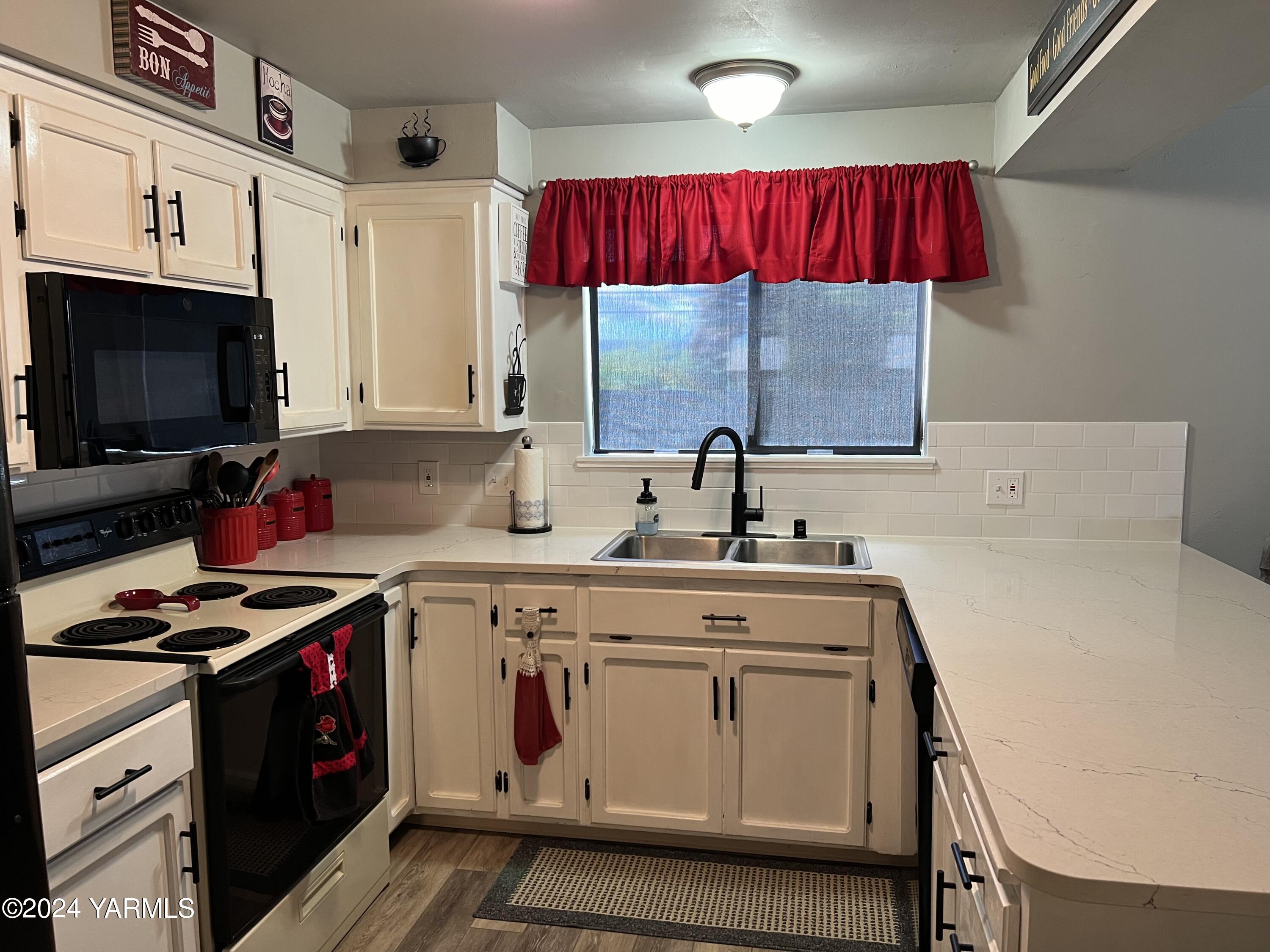 408 Wyant Way Grandview, WA 98930 - Photo 14 of 46 a kitchen with stainless steel appliances granite countertop a sink a stove and a microwave