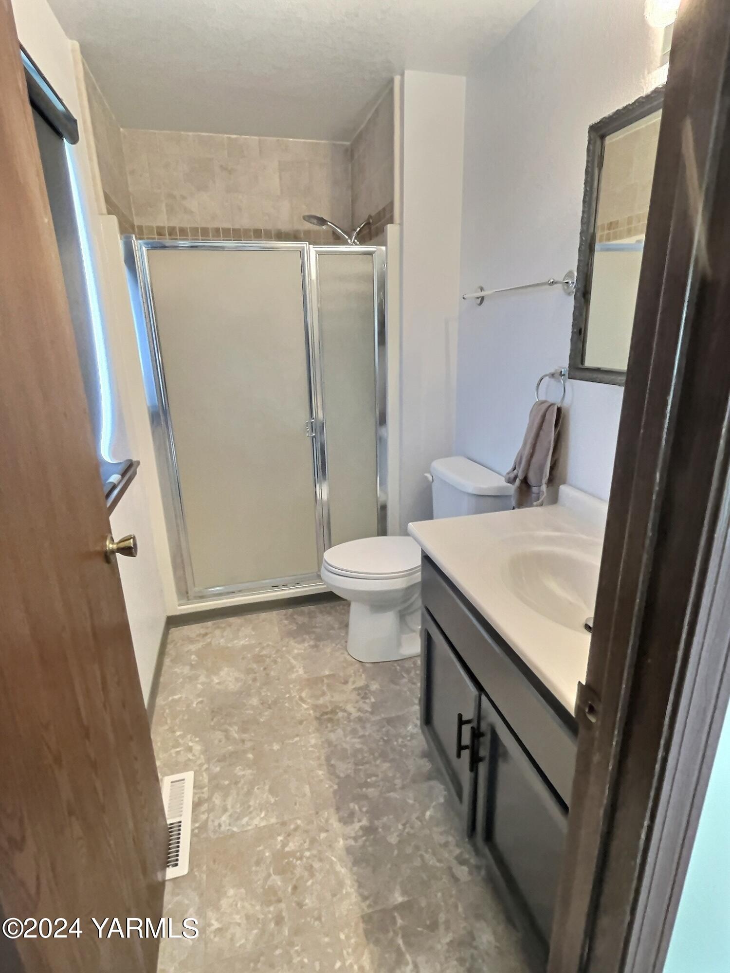 408 Wyant Way Grandview, WA 98930 - Photo 32 of 46 a bathroom with a granite countertop sink toilet and shower