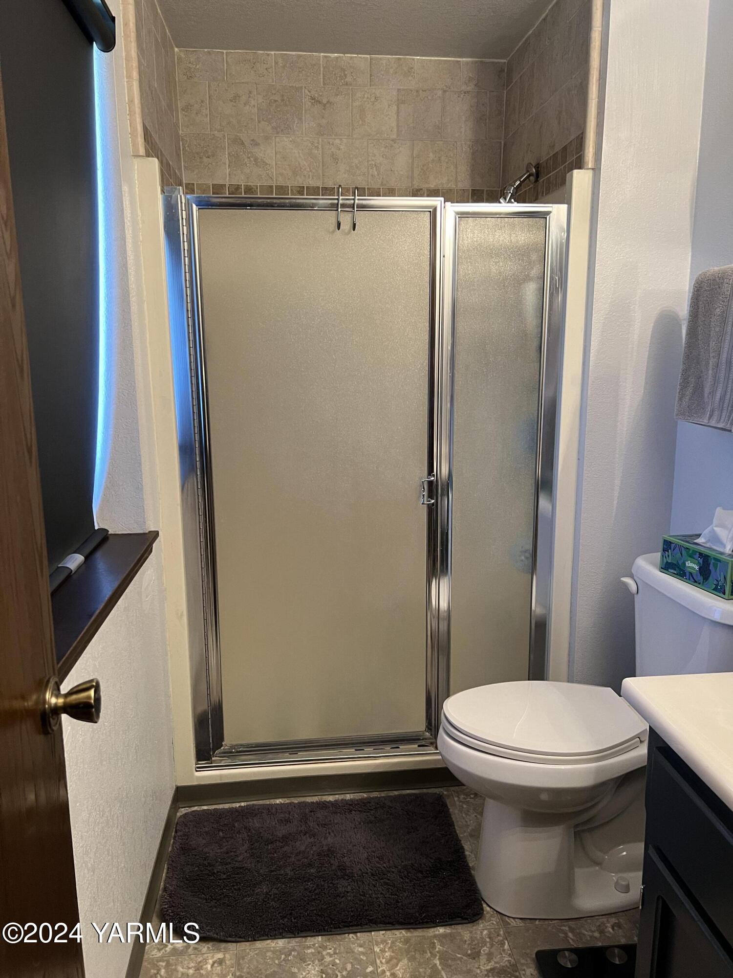 408 Wyant Way Grandview, WA 98930 - Photo 34 of 46 a bathroom with a toilet and a shower