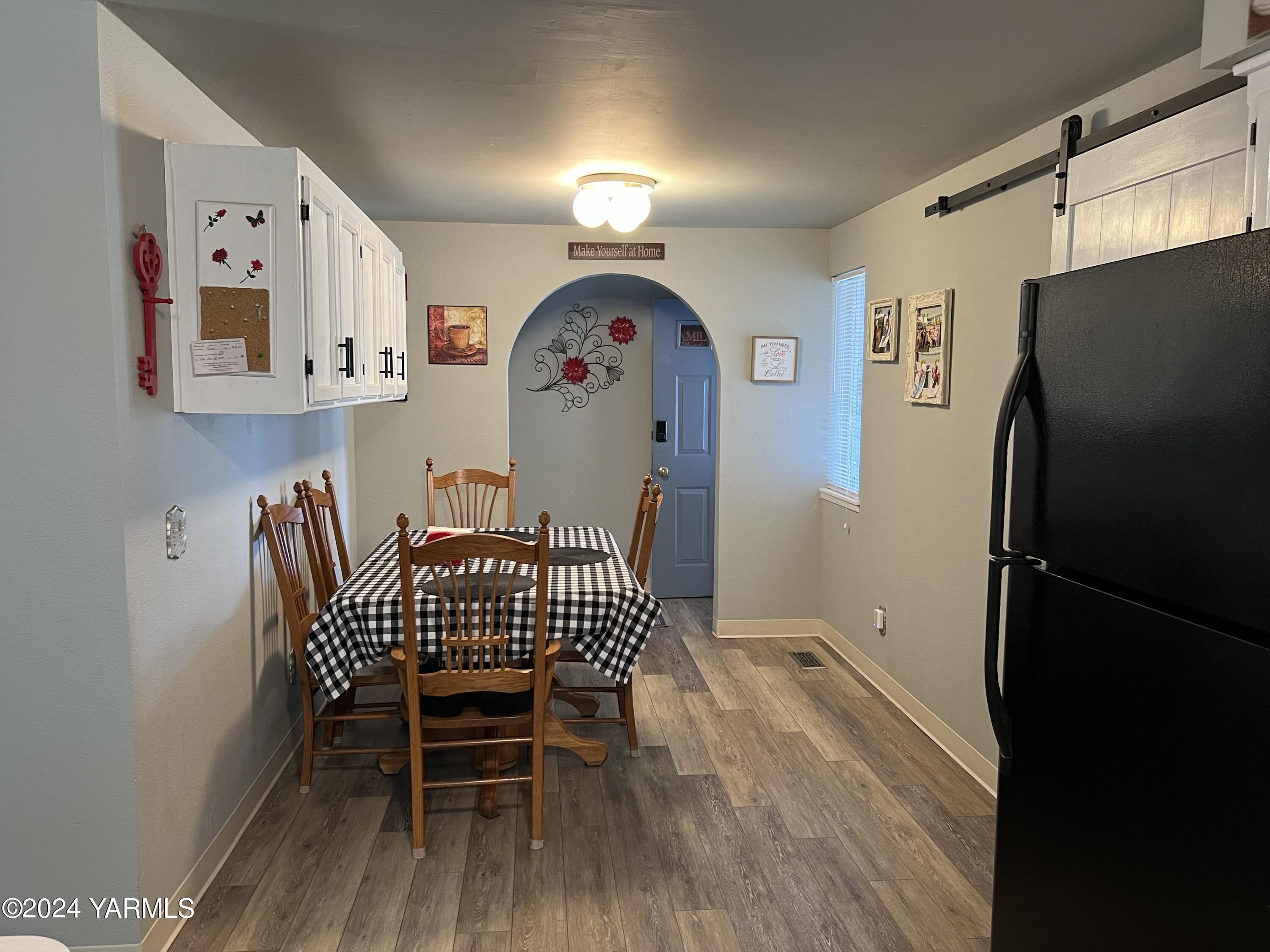 408 Wyant Way Grandview, WA 98930 - Photo 8 of 46 a view of dining room with furniture and wooden floor