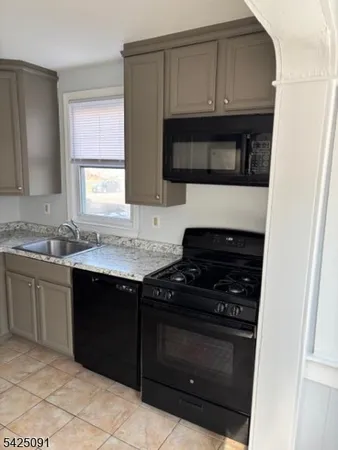 a kitchen with a sink and a stove top oven