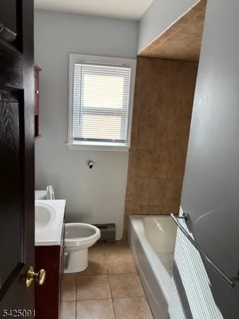 a bathroom with a toilet a sink and bathtub