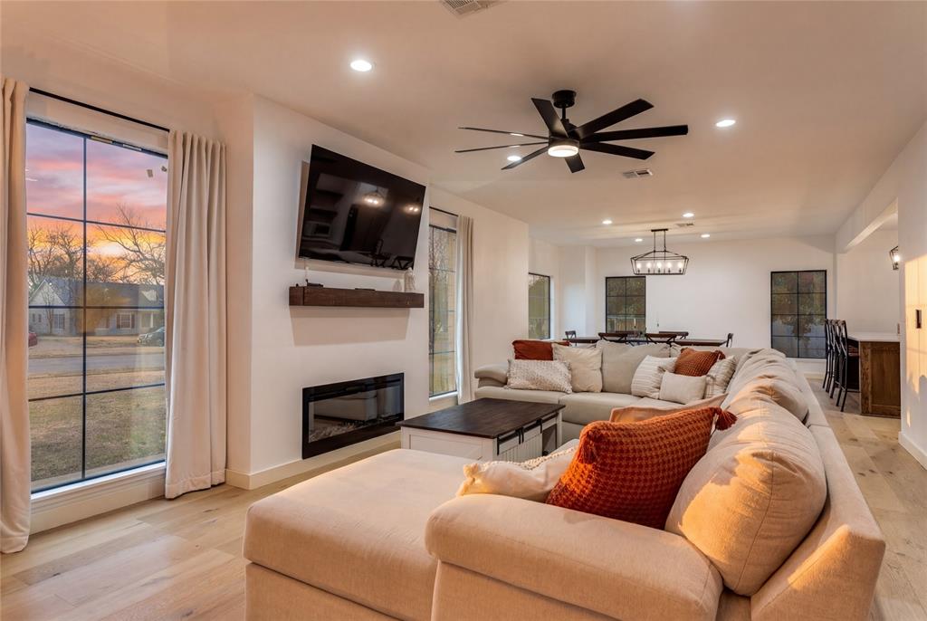 3120 Colcord Avenue Waco, TX 76707 - Photo 5 of 23 a living room with furniture a flat screen tv and a fireplace