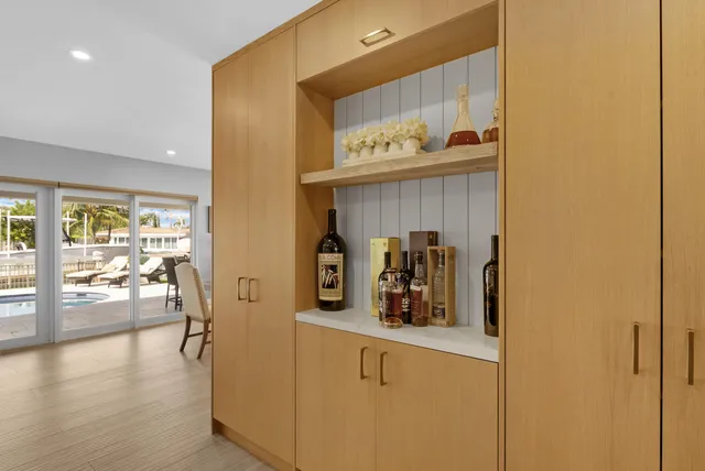 a view of a kitchen with fridge and wooden floor
