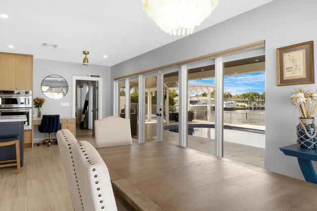 a bedroom with a bed a flat screen tv and a window