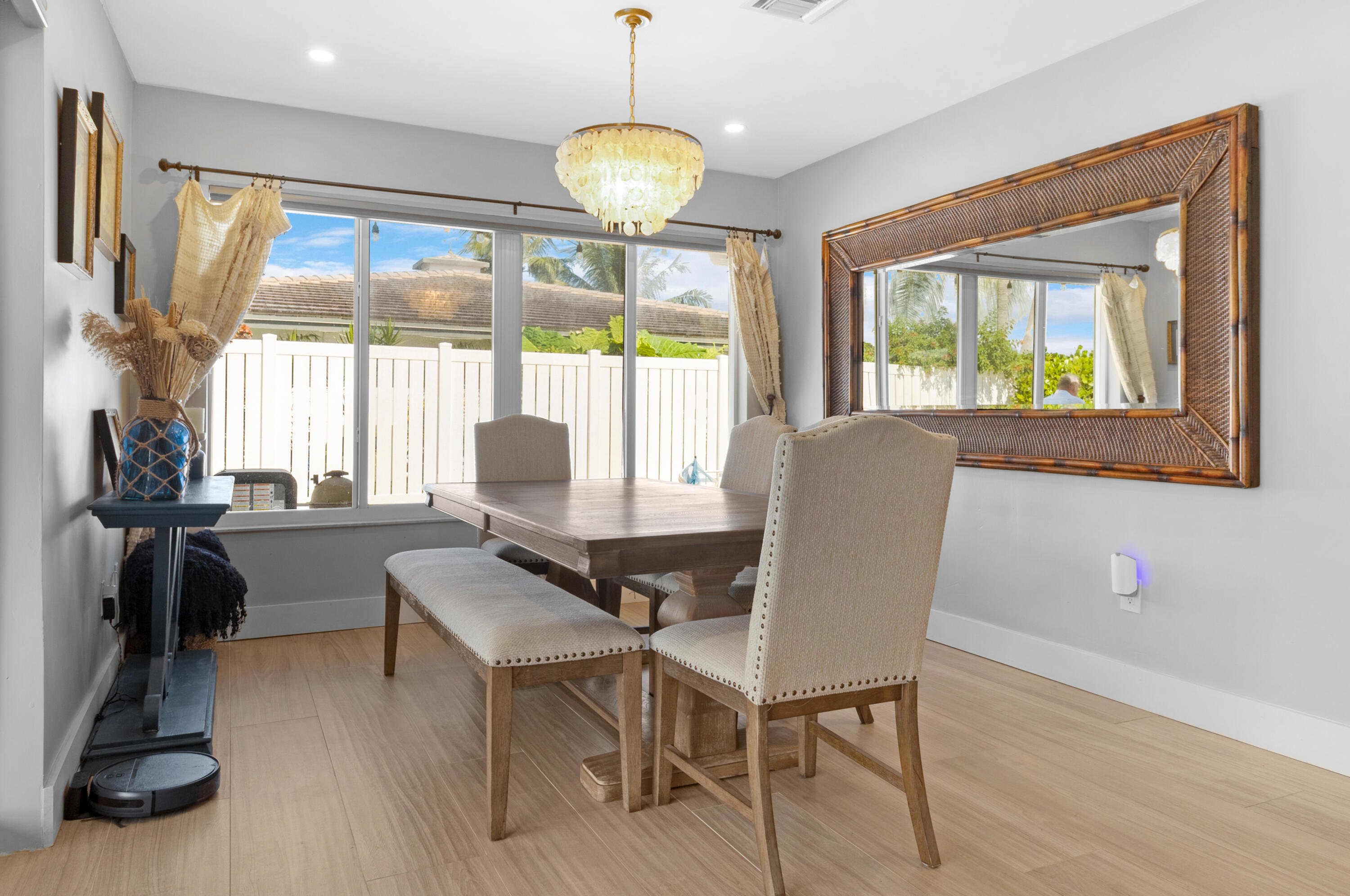 291 Southeast 5th Avenue Pompano Beach, FL 33060 - Photo 15 of 62 a dining room with wooden floor and a floor to ceiling window