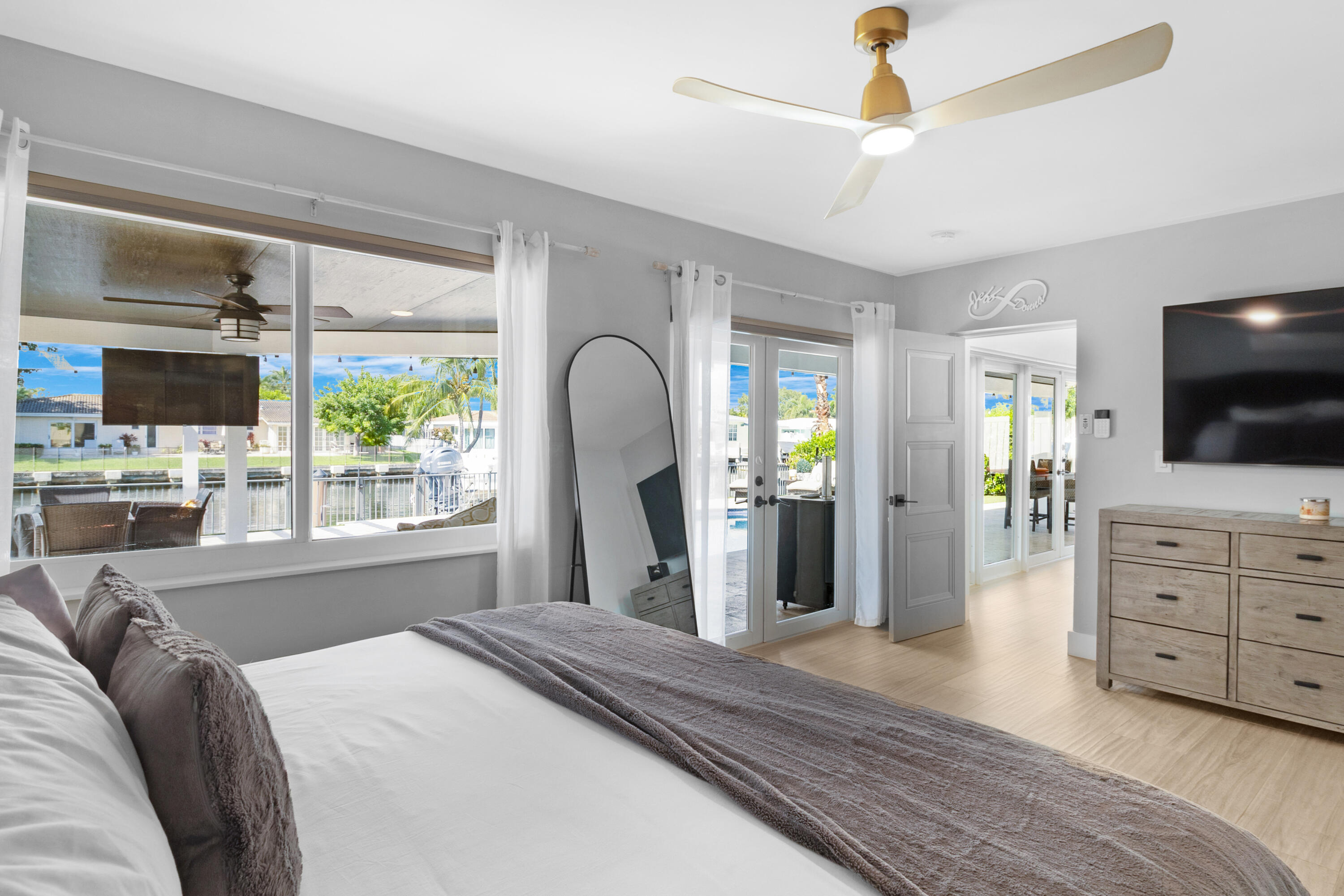 291 Southeast 5th Avenue Pompano Beach, FL 33060 - Photo 16 of 62 a bedroom with a bed a flat screen tv and a window