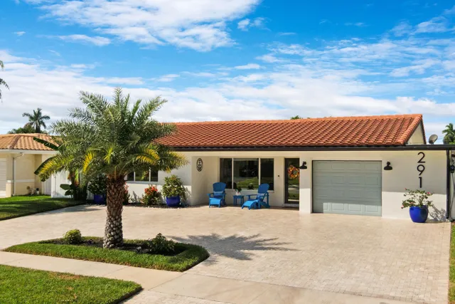 a view of a white house with a yard