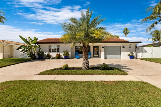 a front view of house with yard and green space