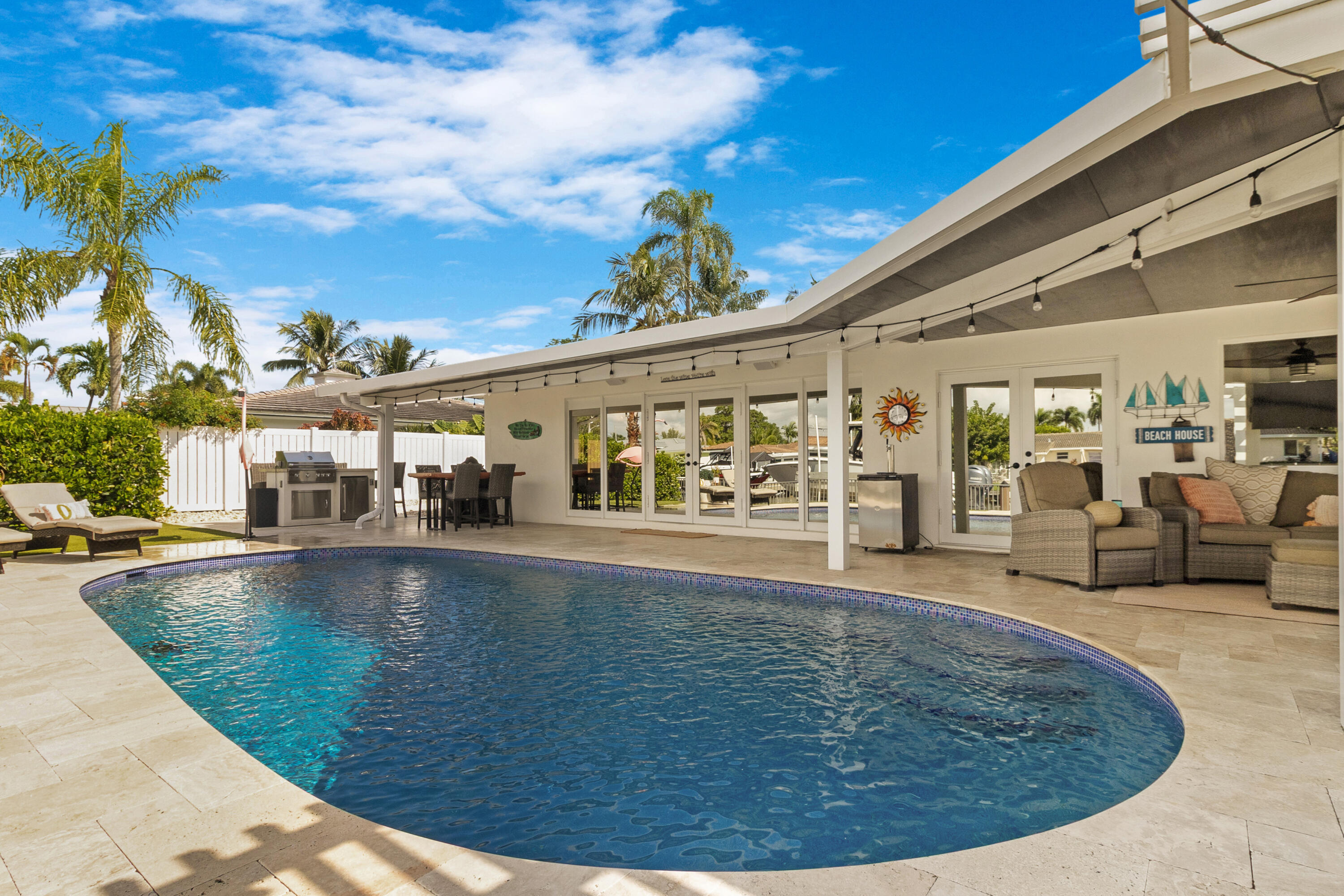 291 Southeast 5th Avenue Pompano Beach, FL 33060 - Photo 32 of 62 a view of a swimming pool with an outdoor seating