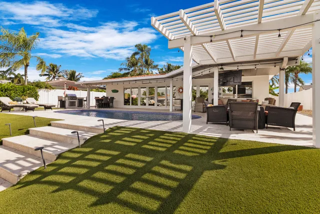 a view of an chairs and swimming pool in the back yard