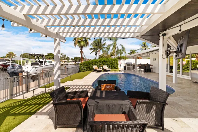 a view of a swimming pool with outdoor seating