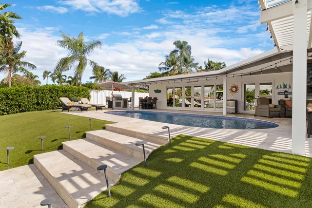 a room with furniture and pool