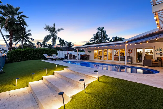 a view of house with outdoor space and swimming pool