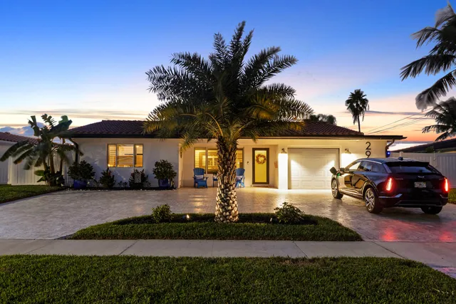 a front view of a building with a garden