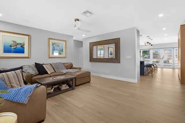 a living room with furniture and painting on the wall