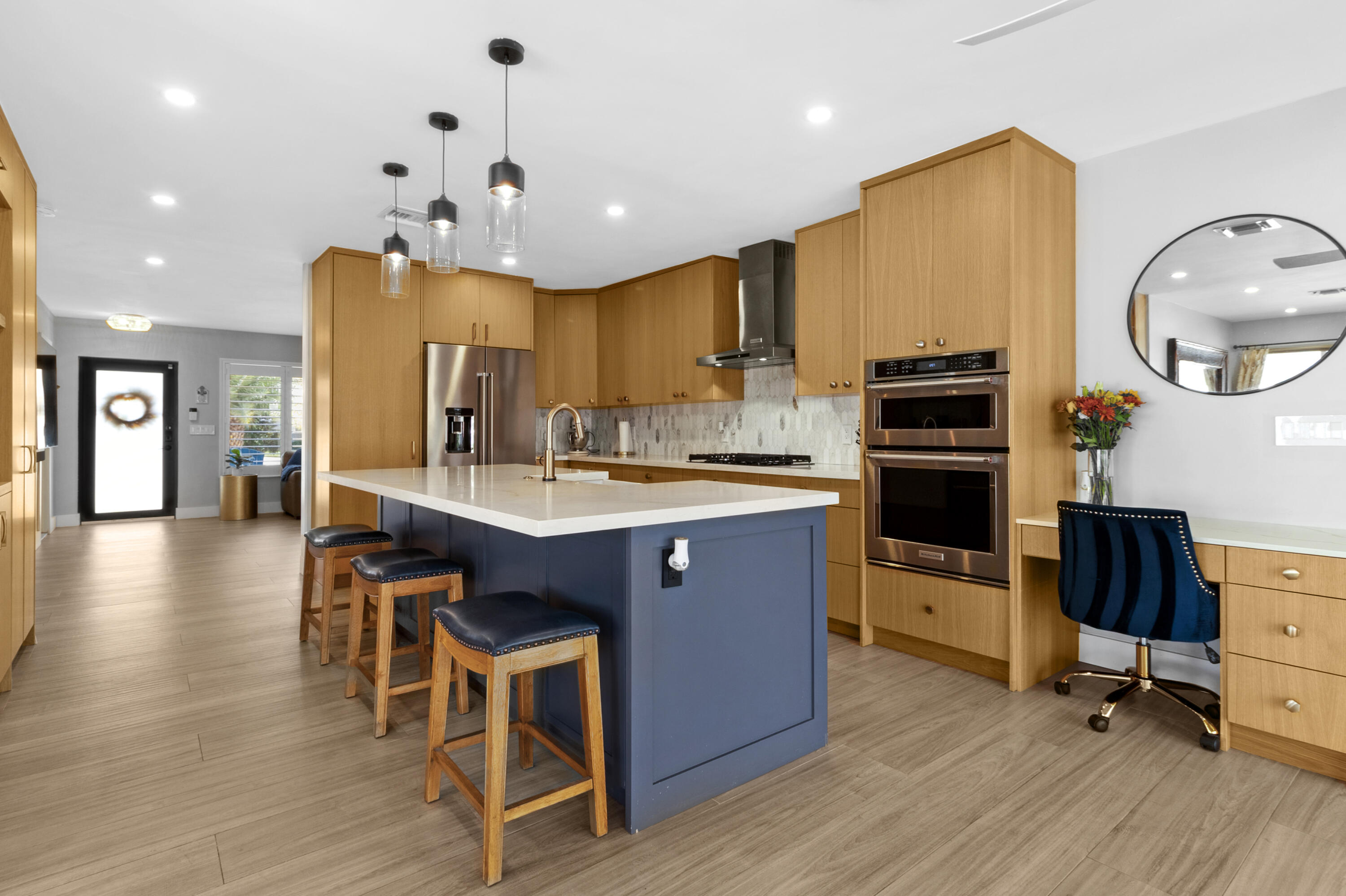 291 Southeast 5th Avenue Pompano Beach, FL 33060 - Photo 9 of 62 a kitchen with stainless steel appliances kitchen island granite countertop a stove a sink a refrigerator and chairs with wooden floor