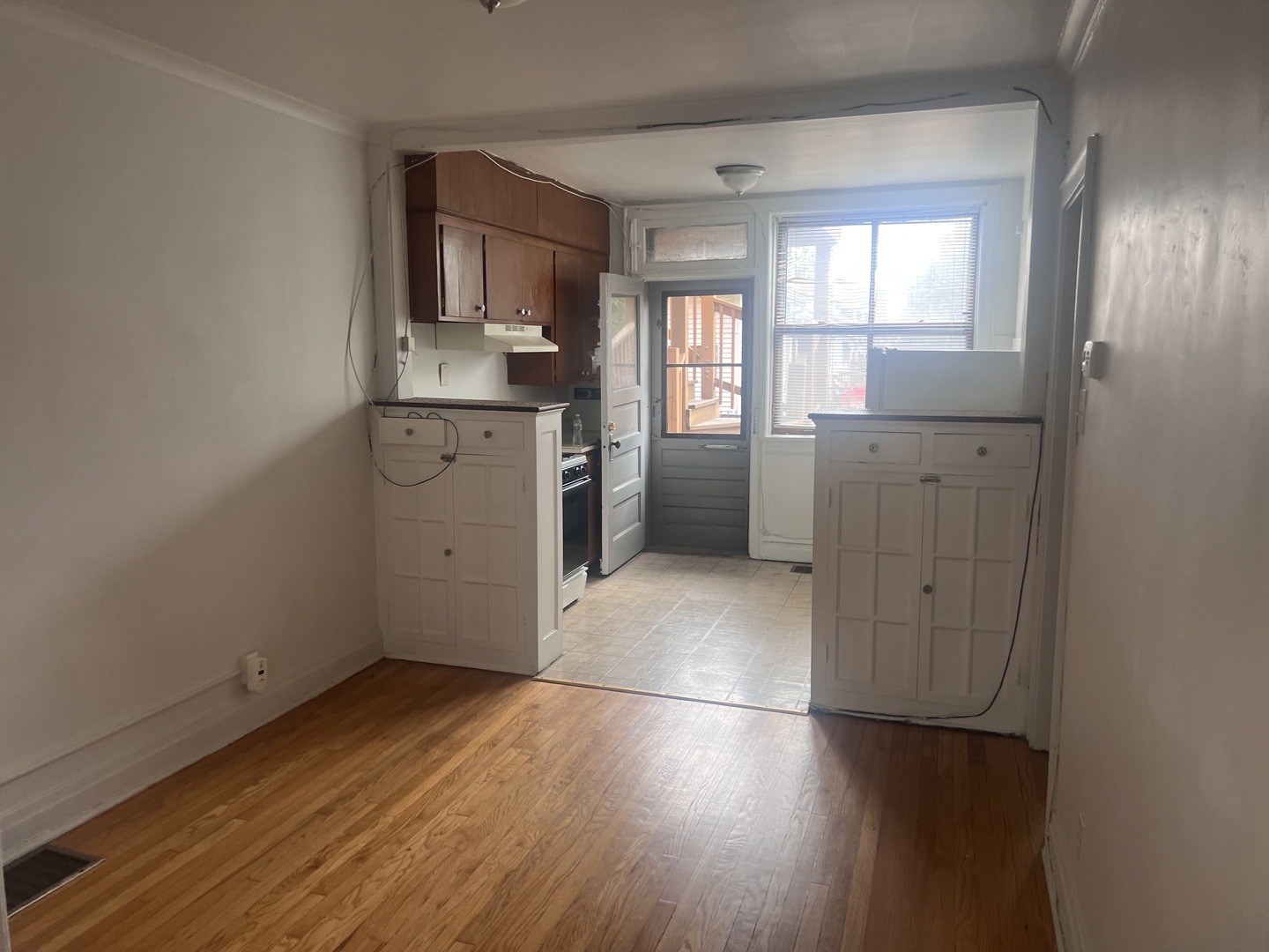 5907 West Arthington Street, Unit 1 Chicago, IL 60644 - Photo 8 of 16 a view of a kitchen with wooden floor and electronic appliances