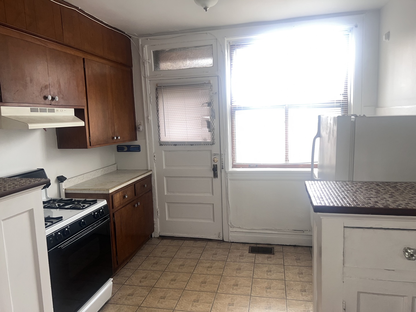 5907 West Arthington Street, Unit 1 Chicago, IL 60644 - Photo 15 of 16 a kitchen with a sink stove and cabinets
