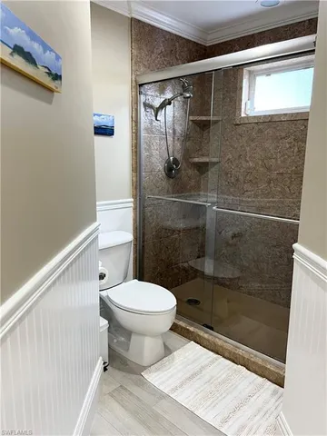 a bathroom with a toilet and a shower