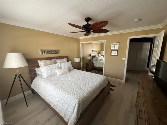 a spacious bedroom with a bed and a chandelier