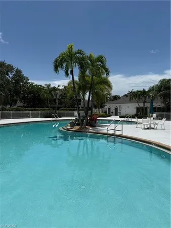 a view of a swimming pool with a table and chairs