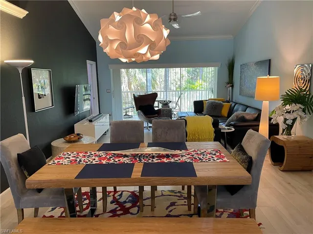 a bedroom with furniture and a large window