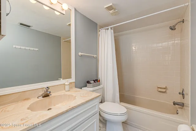 a view of a swimming pool with a lawn chairs under palm trees