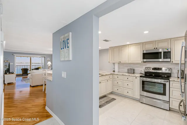 a kitchen with granite countertop a sink white cabinets and a granite counter tops