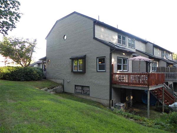 19 Highfield Road, Unit D Charlton, MA 01507 - Photo 2 of 19 a backyard of a house with table and chairs