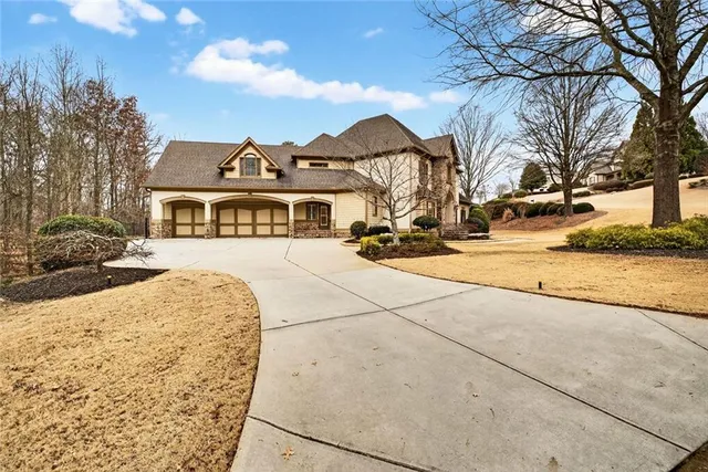 a view of an empty room with wooden floor and a fireplace